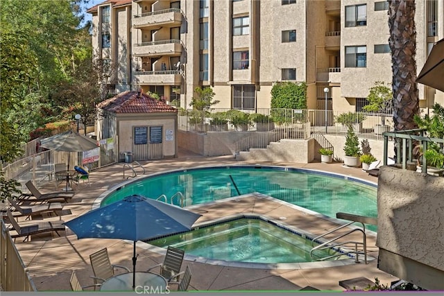 view of swimming pool with a community hot tub