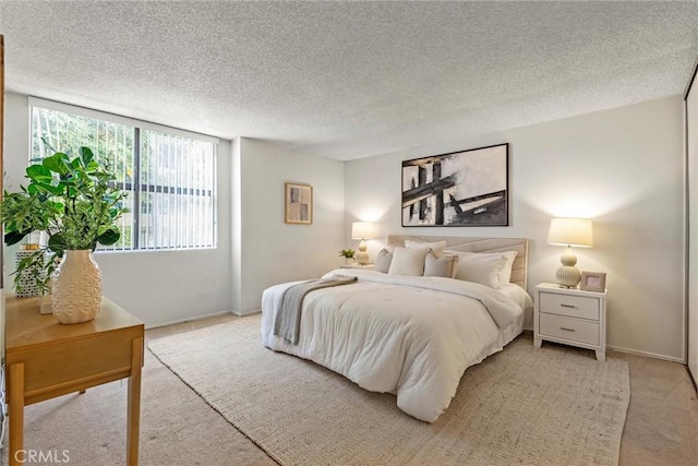 bedroom featuring carpet and a textured ceiling