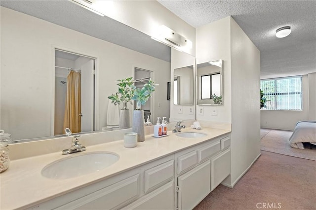 bathroom with vanity and a textured ceiling