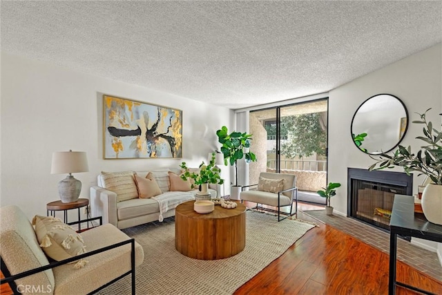 living room with hardwood / wood-style flooring and a textured ceiling