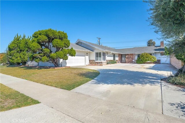 ranch-style home featuring a garage and a front lawn