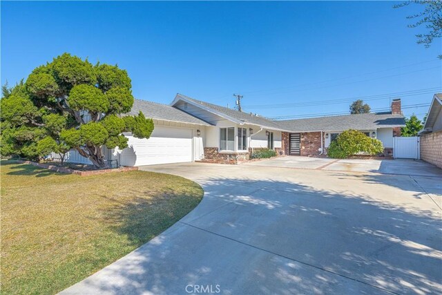 single story home featuring a garage and a front yard