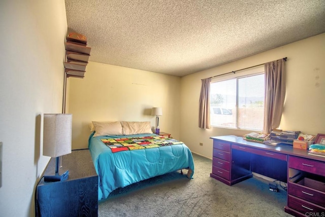 bedroom featuring carpet floors and a textured ceiling