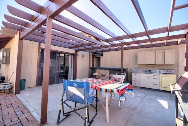 view of patio / terrace featuring an outdoor kitchen and a pergola