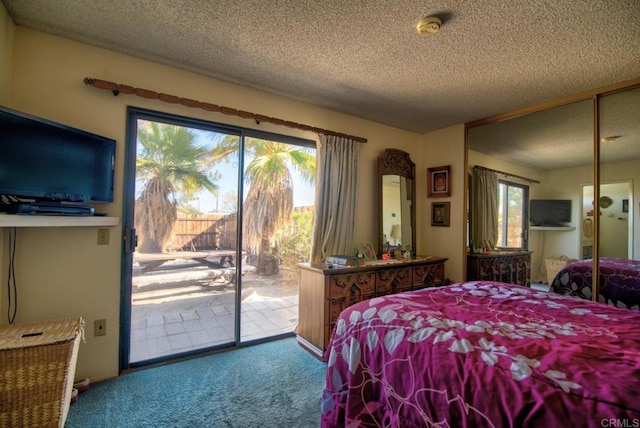 bedroom featuring carpet flooring, access to exterior, and a textured ceiling