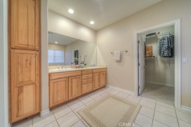 bathroom featuring tile patterned flooring and vanity