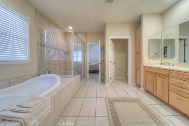 bathroom featuring tile patterned flooring, vanity, and independent shower and bath