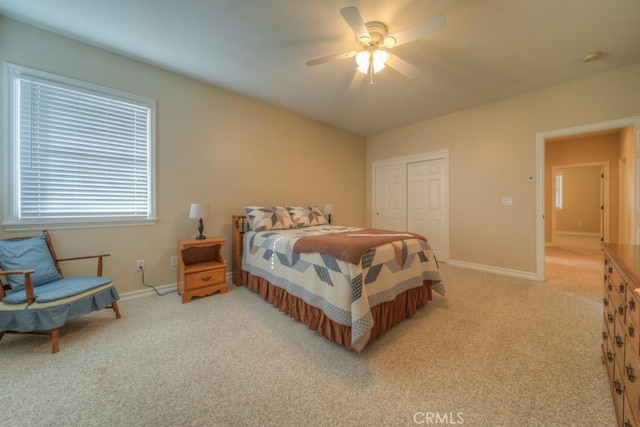 carpeted bedroom with a closet and ceiling fan