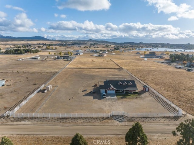 birds eye view of property featuring a mountain view and a rural view