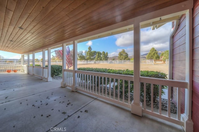 view of patio / terrace featuring covered porch and a rural view