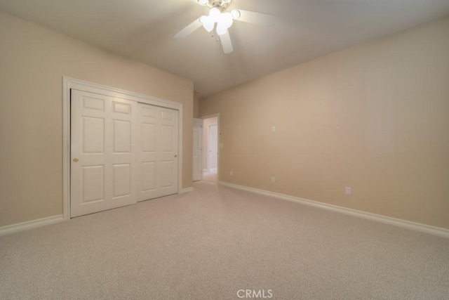 unfurnished bedroom featuring carpet flooring, a closet, and ceiling fan