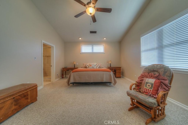 bedroom with ceiling fan, ensuite bathroom, light carpet, and lofted ceiling