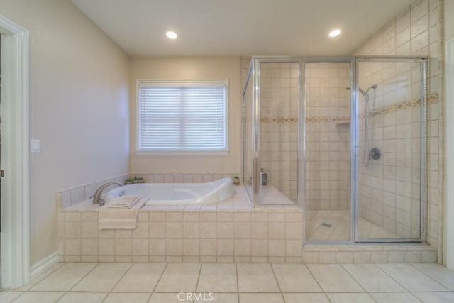 bathroom with tile patterned flooring and shower with separate bathtub