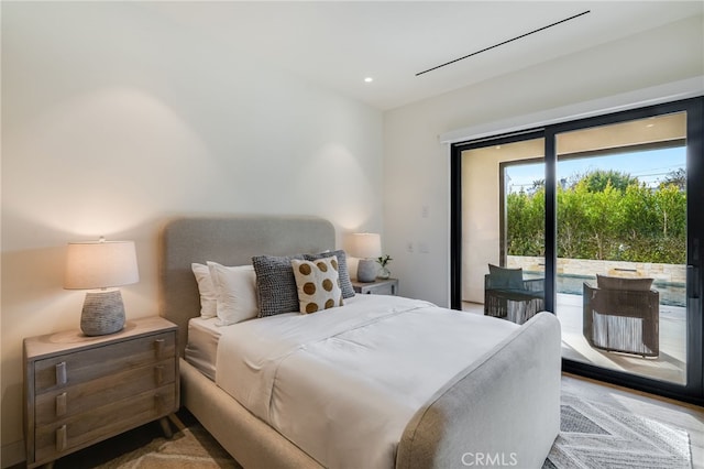 bedroom with access to exterior and wood-type flooring