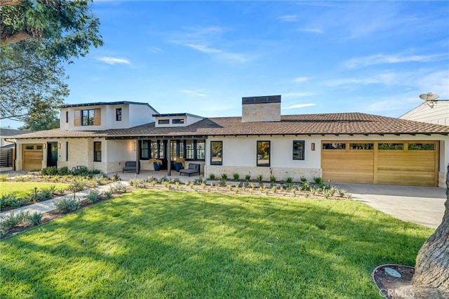 view of front of home featuring a front yard and a garage