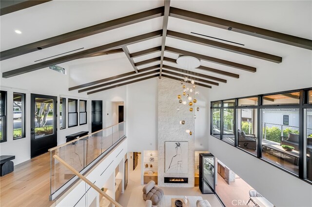 427 Santa Ana Ave, Newport Beach, CA 92663 - living area featuring beamed ceiling, wine cooler, a large fireplace, wood finished floors, and a chandelier