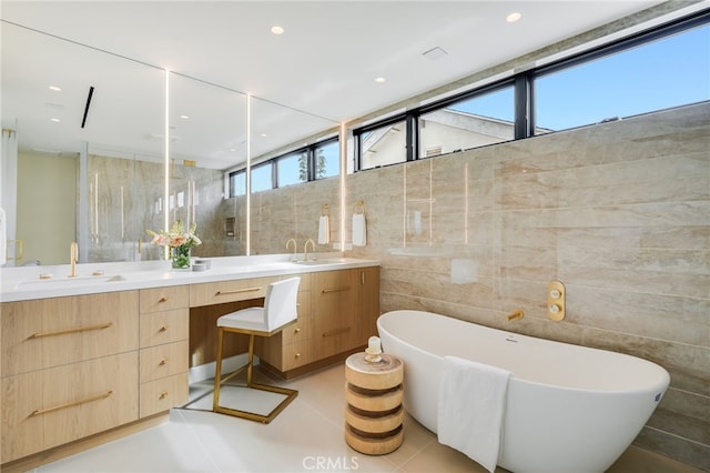 bathroom with a bathtub, tile walls, and a wealth of natural light