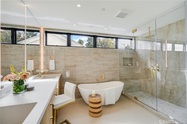 427 Santa Ana Ave, Newport Beach, CA 92663 - bathroom featuring double vanity, a stall shower, a soaking tub, tile patterned flooring, and tile walls