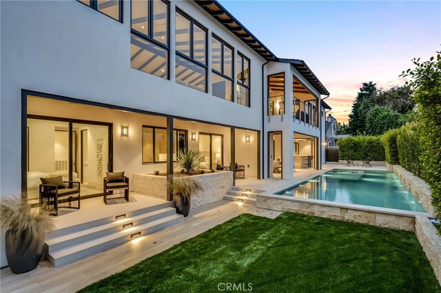427 Santa Ana Ave, Newport Beach, CA 92663 - rear view of house with a balcony, a patio, stucco siding, and a yard