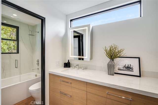 full bathroom featuring vanity, toilet, and tiled shower / bath combo