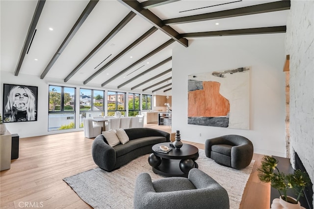 living room featuring beam ceiling, high vaulted ceiling, and light wood-type flooring