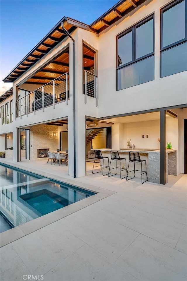 427 Santa Ana Ave, Newport Beach, CA 92663 - rear view of property featuring a balcony, stucco siding, and a bar