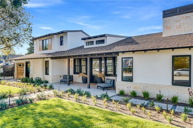 rear view of house featuring a lawn, a patio area, and an outdoor hangout area