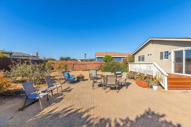 view of patio featuring a deck and an outdoor fire pit