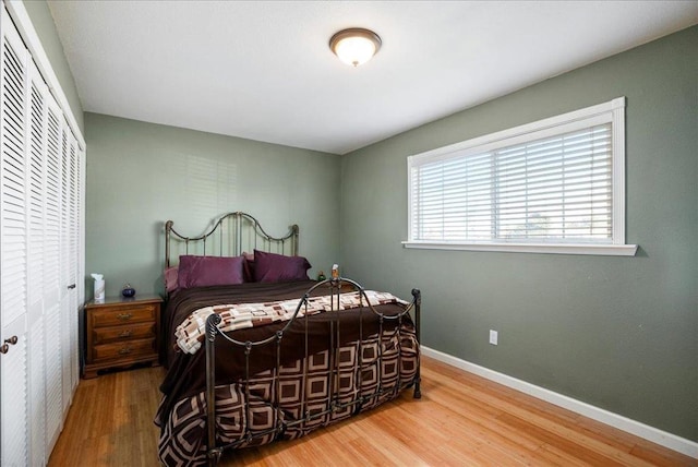 bedroom with wood-type flooring and a closet