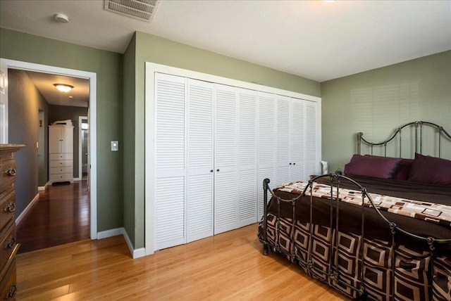 bedroom with a closet and wood-type flooring