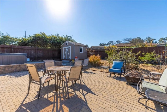 view of patio featuring an outdoor fire pit and a storage unit