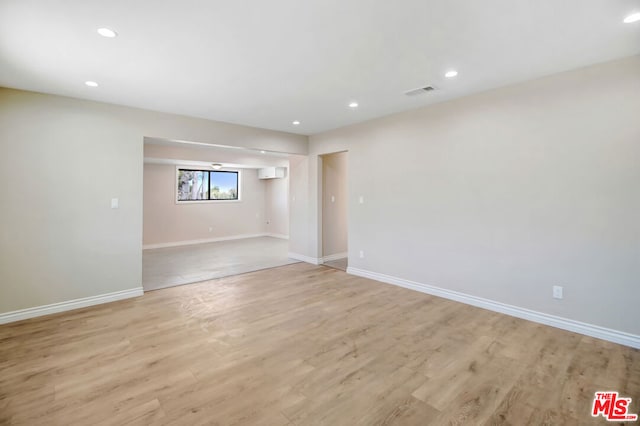 unfurnished room with light wood-type flooring