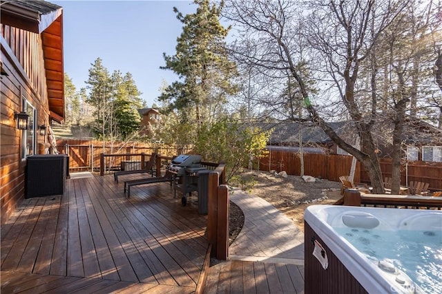 wooden terrace with a hot tub