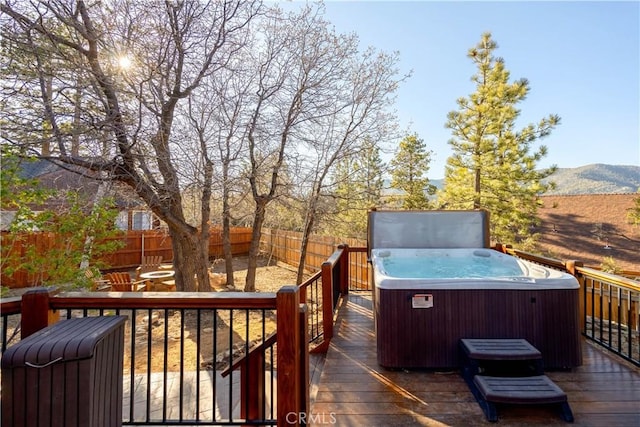 wooden terrace with a mountain view and a hot tub