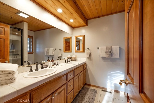 bathroom with vanity, wooden ceiling, a shower with door, tile patterned floors, and toilet