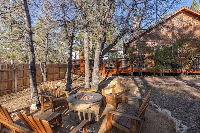 exterior space featuring a deck and an outdoor fire pit