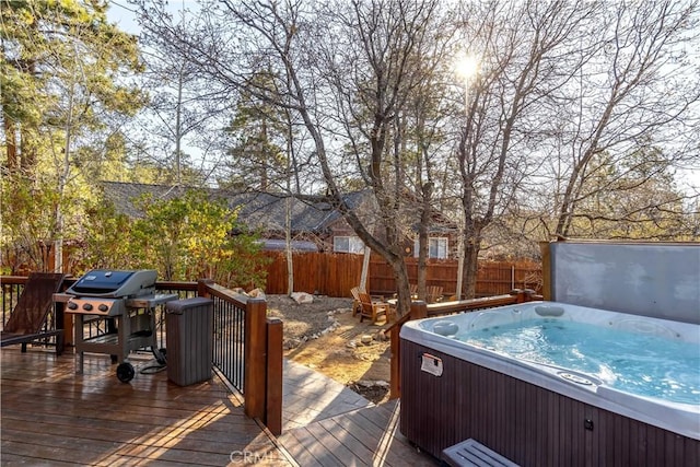 deck with a grill and a hot tub