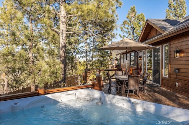 exterior space featuring a wooden deck and a hot tub