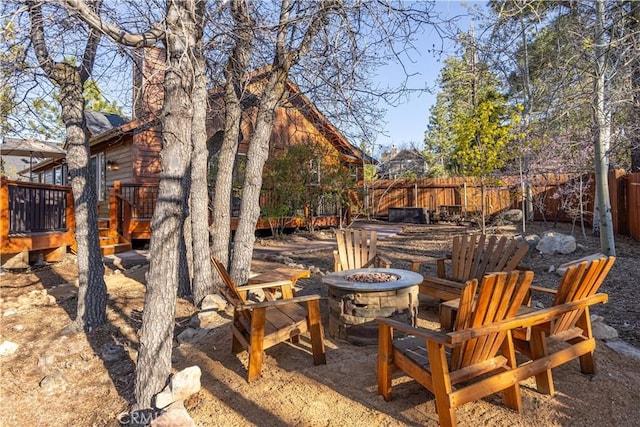 view of yard featuring a fire pit and a deck