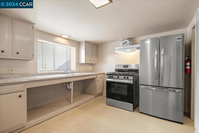 kitchen featuring appliances with stainless steel finishes, exhaust hood, and sink