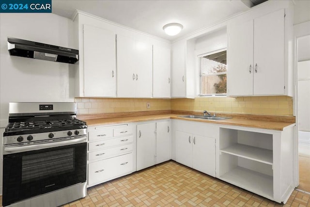 kitchen with sink, tasteful backsplash, stainless steel gas range oven, extractor fan, and white cabinets