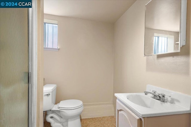 bathroom with vanity, toilet, and a shower with shower door