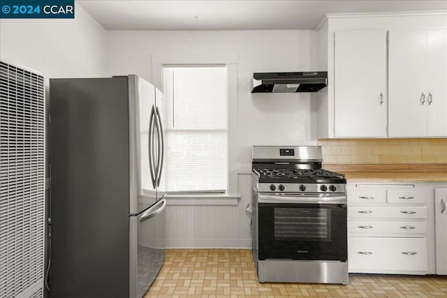 kitchen featuring backsplash, white cabinetry, and appliances with stainless steel finishes