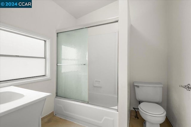 full bathroom featuring sink, bath / shower combo with glass door, vaulted ceiling, and toilet