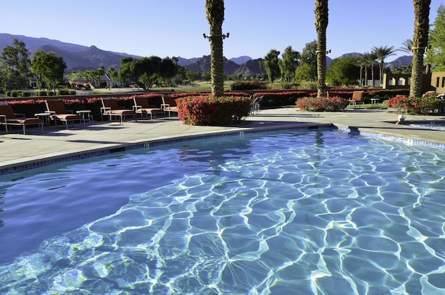 view of pool featuring a mountain view and a patio area