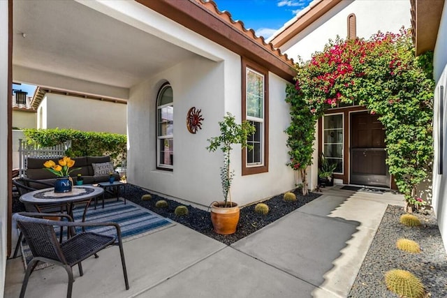 doorway to property with outdoor lounge area and a patio area