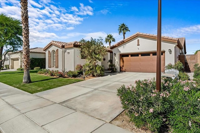 mediterranean / spanish-style home featuring a front yard and a garage