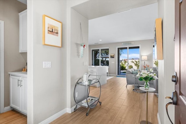 hall with light hardwood / wood-style floors