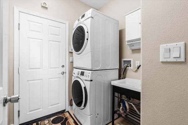 washroom featuring stacked washer / dryer