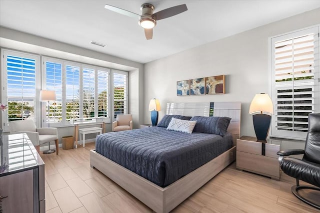 bedroom with ceiling fan and light wood-type flooring